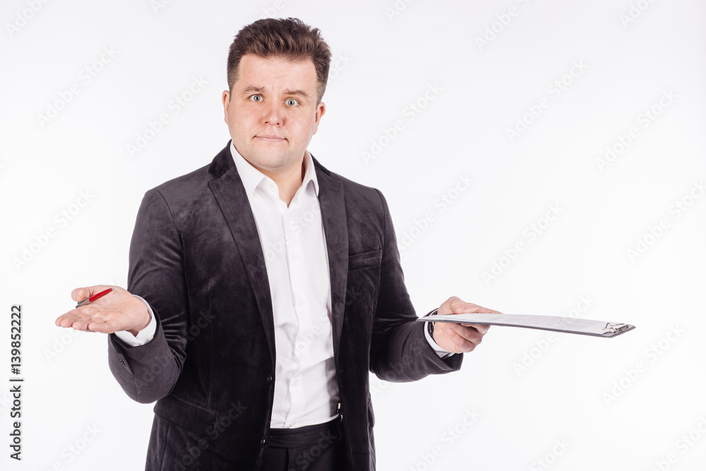 young business man standing and writing in folder on a white background. young business man standing and writing in folder on a white background.