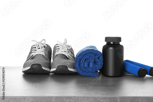 Sports concept. Workout objects on grey table and white background
