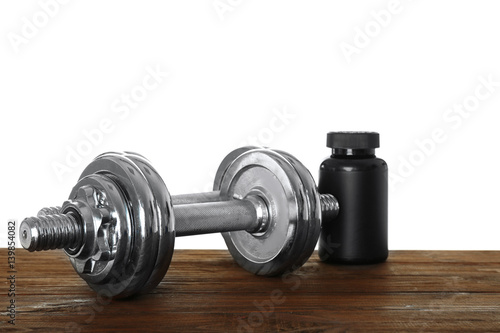 Sports concept. Workout objects on wooden table and white background