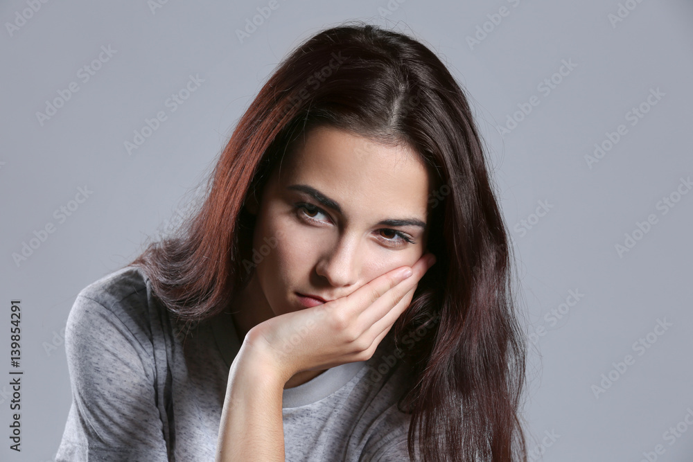 Depressed young woman on color background Depressed young woman on color background