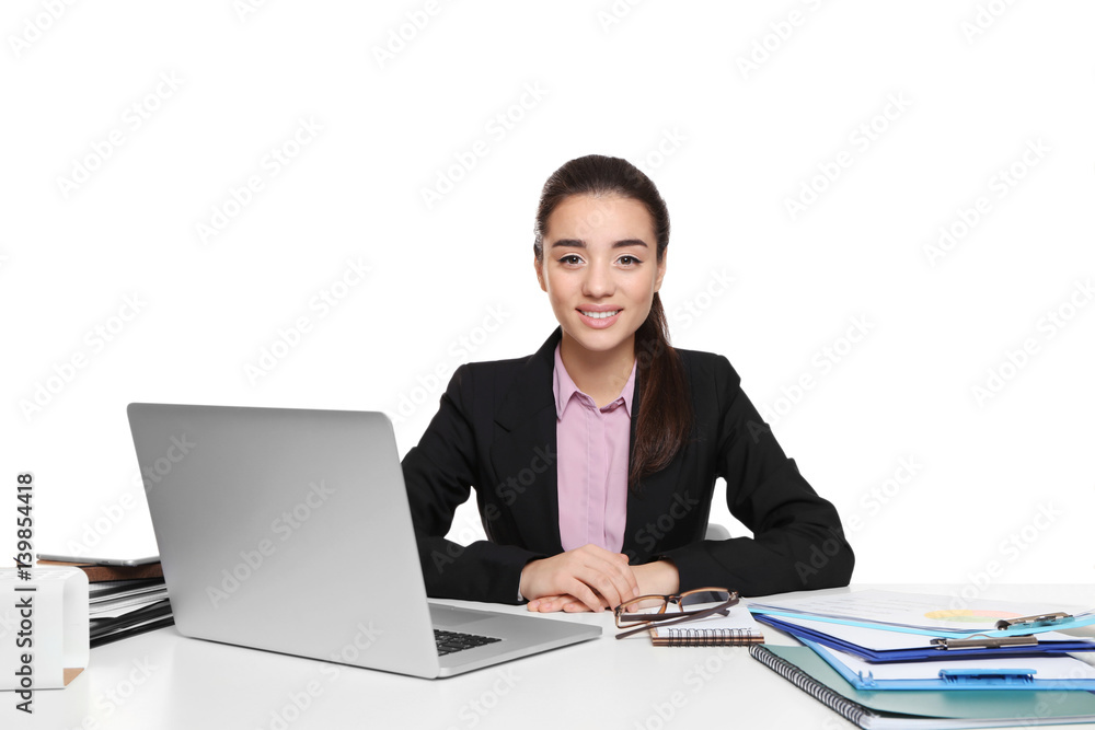 Beautiful young woman sitting at table with laptop, on white background Beautiful young woman sitting at table with laptop, on white background