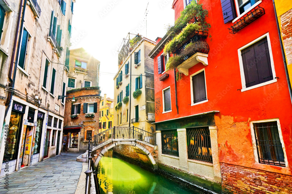 View of the colorful Venetian houses with bridges across on the canal in Venice