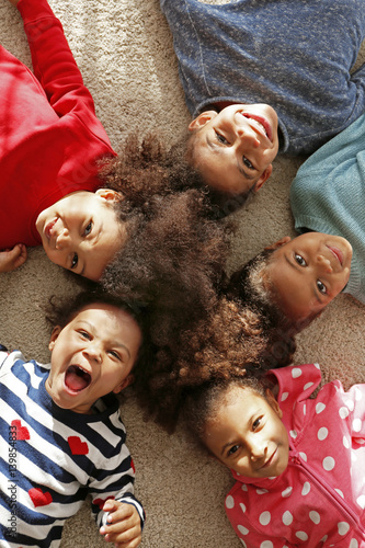 Five cute African girls lyi...