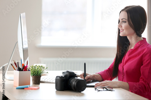 Young female designer worki...