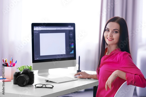Young female designer worki...