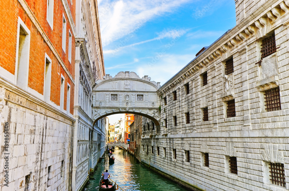 View of the Bridge of Sighs with Gondolas punted by gondoliers on the canal in Venice