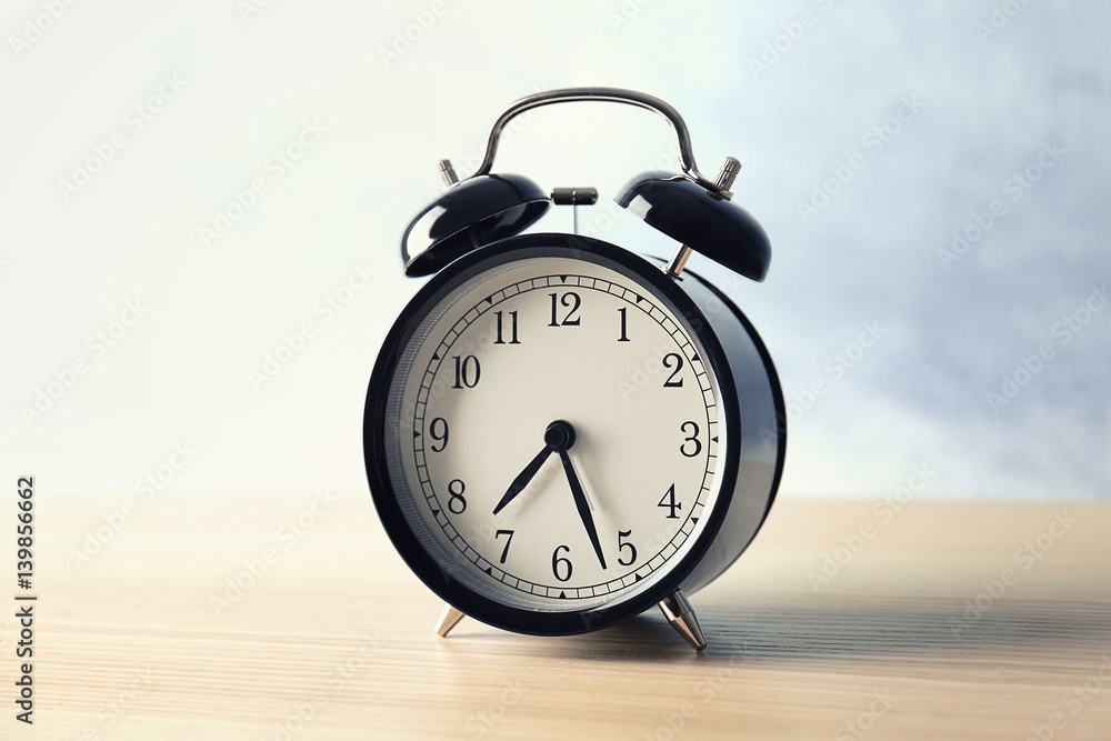 Alarm clock on wooden table Alarm clock on wooden table