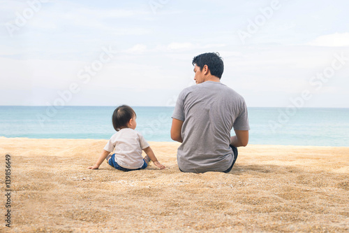 Father and daughter playing at beach. Healthy father and daughter playing together at the beach carefree happy fun smiling lifestyle.