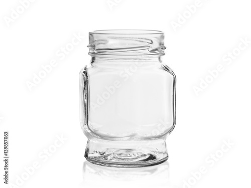 Empty glass jar of unusual shape with shadow and reflection on white background