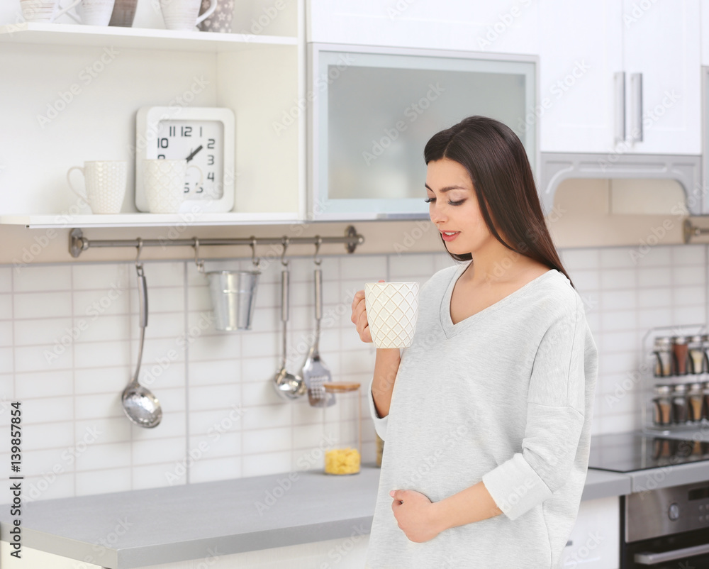 Beautiful pregnant woman in kitchen Beautiful pregnant woman in kitchen