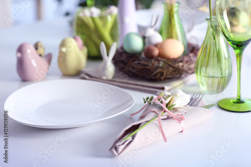 Beautiful Easter table setting on blurred background