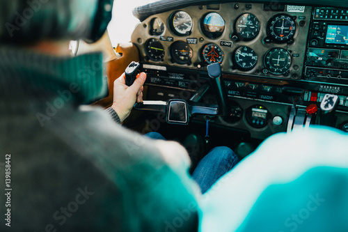Flight instructor and student inside small Piper aircraft