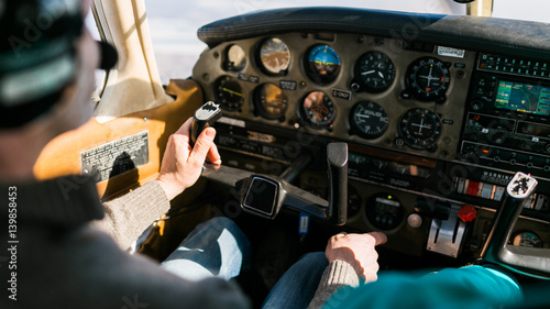 Flight instructor and student inside small Piper aircraft