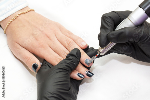 Woman hands doing manicure beauty salon close-up