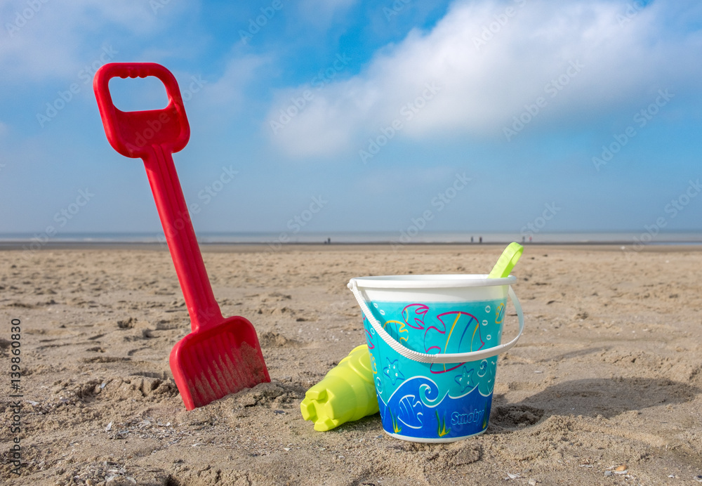 Children's bucket and spade on the beach of De Haan, Belgium. Children's bucket and spade on the beach of De Haan, Belgium.