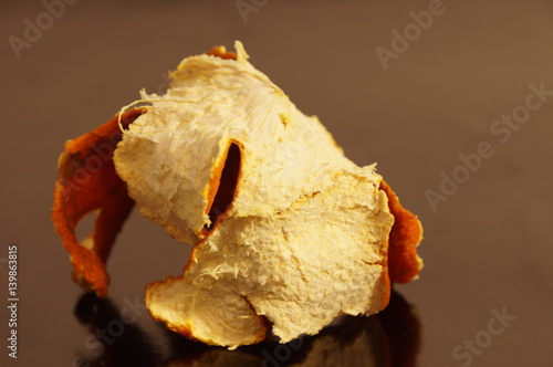 Mandarin crust is dried and isolated on a monophonic background. Zedra on the background