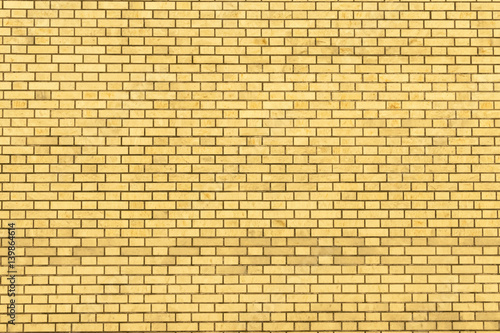 A yellow wall made of brick for background and texture.