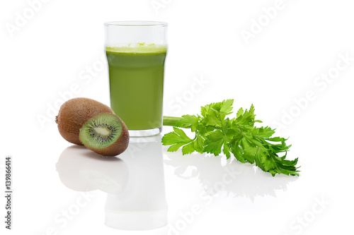 Glass of fresh kiwi, celery and apple juice with reflection on white background. Ingredient for smoothie.