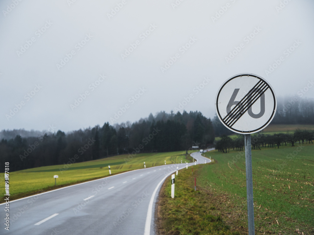 Naklejka premium End of speed limit with curvy road