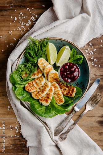 Fried Homemade halumi cheese with cowberry sauce, lemon and hrebs