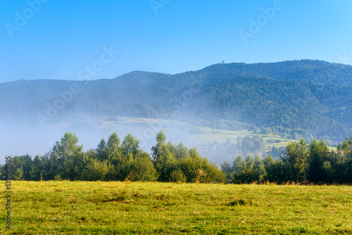 Picturesque rural landscape in misty morning. Pieniny mountains. Poland.