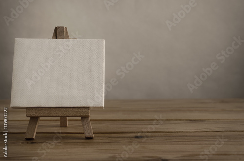 Blank Canvas and Easel on Wood Planking