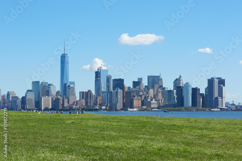 New York city skyline and green meadow, blue sky in a sunny day
