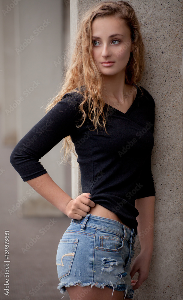Pretty Teen in Black Top and Jean Shorts Outside Photos | Adobe Stock