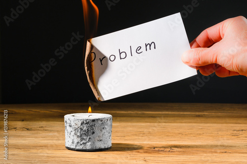 Concept solution probem by burning text on paper photo