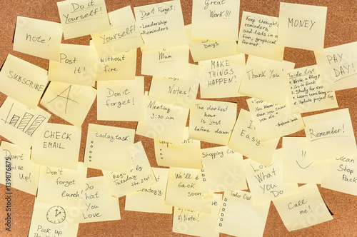 Many stickers for notes with text on the cork board