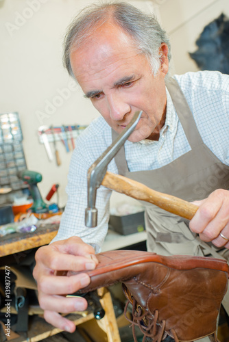 cobbler working on a shoe photo