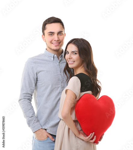 Young woman hiding pillow i...