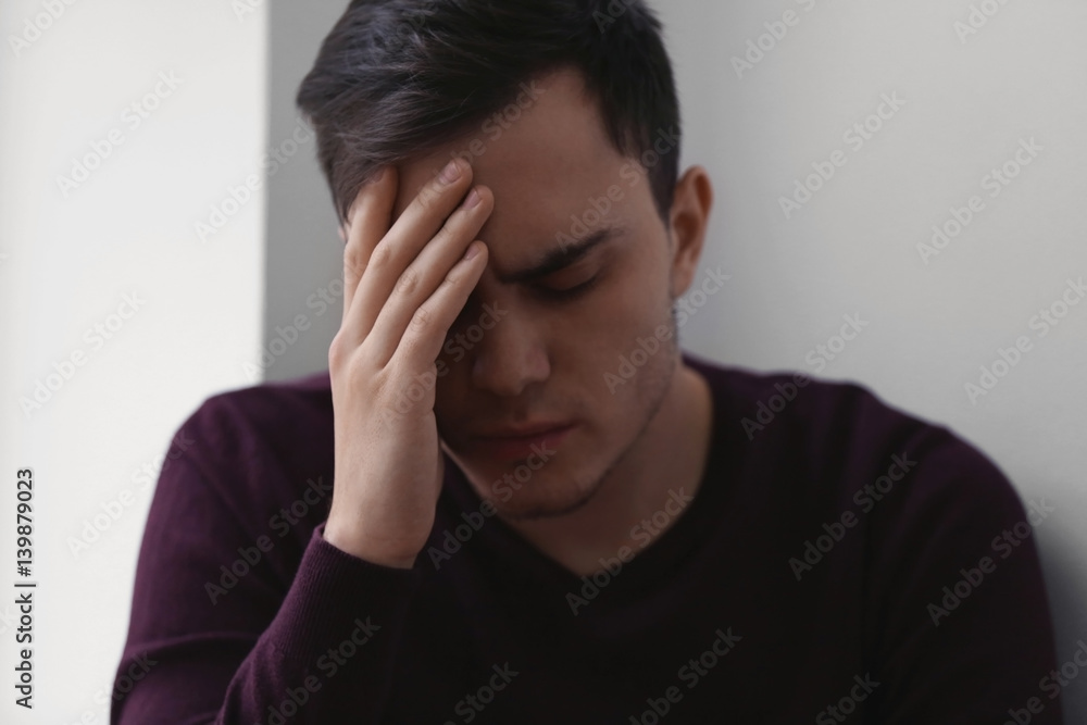 Handsome depressed man at home Handsome depressed man at home