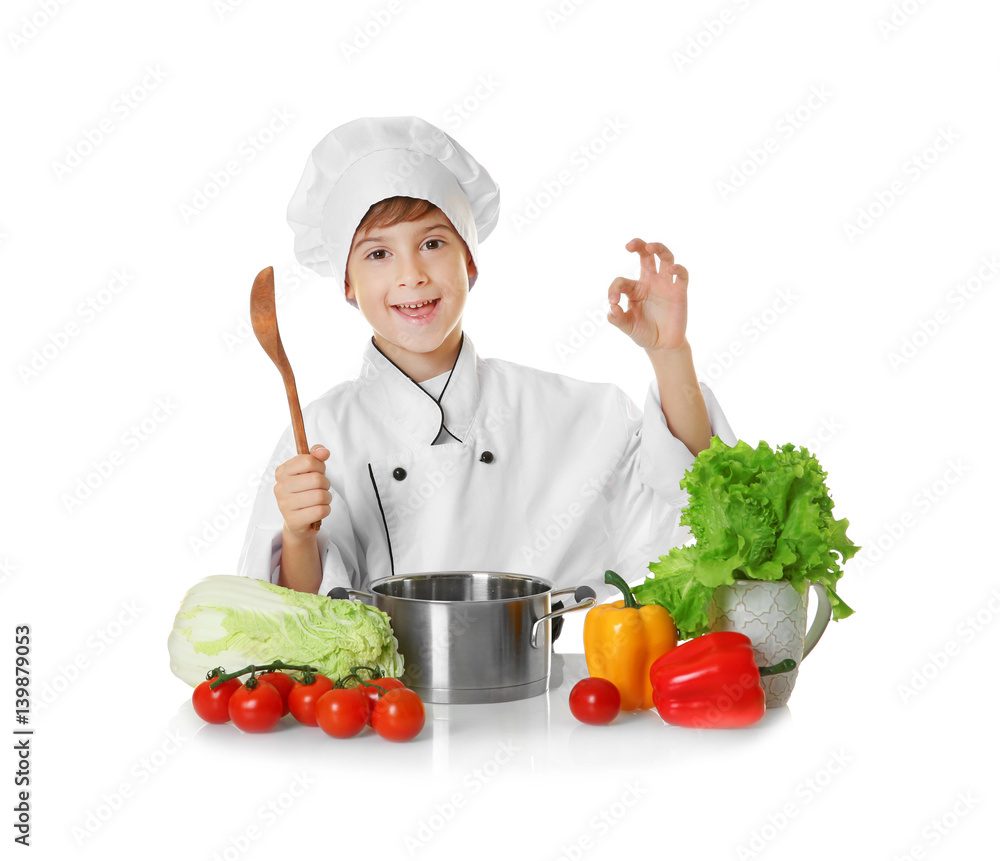 Cute boy in chef uniform preparing tasty soup, on white background Cute boy in chef uniform preparing tasty soup, on white background