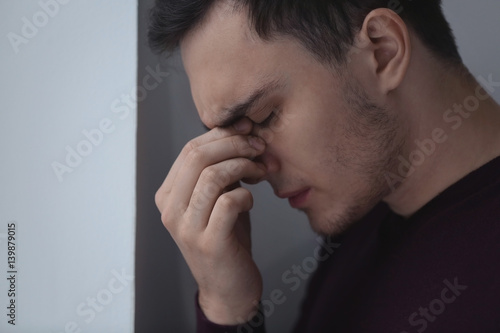 Handsome depressed man at home