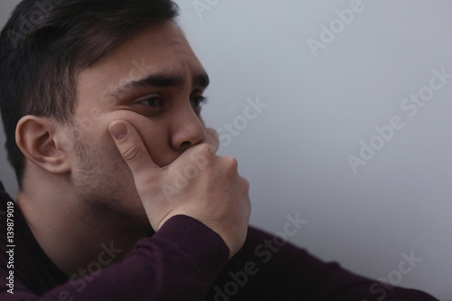 Handsome depressed man at home