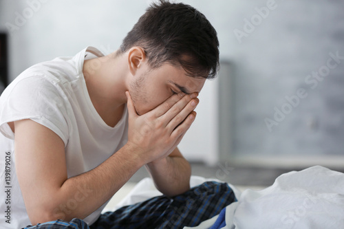 Handsome depressed man on b...
