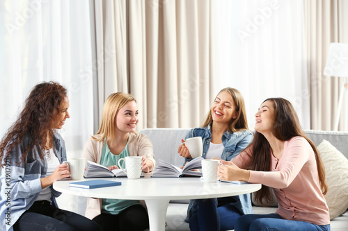 Women sitting at table in book club