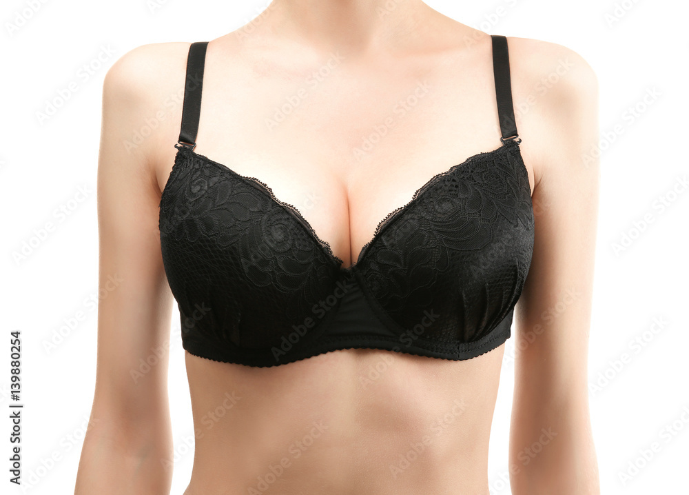 Young woman in black bra on white background Young woman in black bra on white background