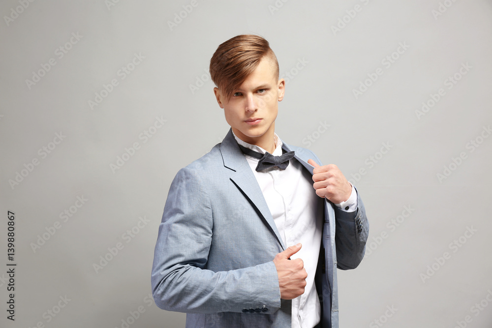 Handsome young man on grey background Handsome young man on grey background