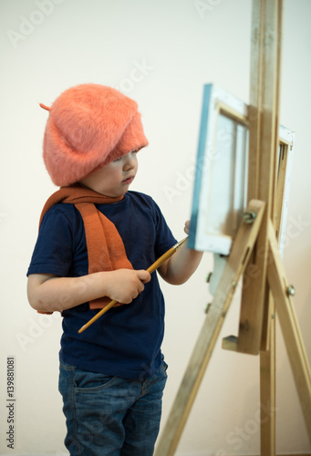 Little boy artist at the easel