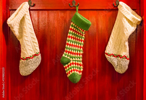 Three Stockings Hanging on Hooks