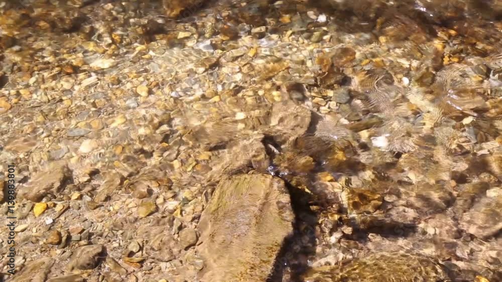 Sunny rocky mountain stream flowing closeup in the forest. Top view. Slider dolly used. Sunny rocky mountain stream flowing closeup in the forest. Top view. Slider dolly used.