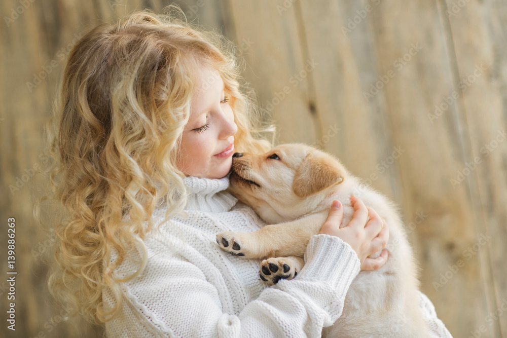 Little girl with a labrador puppy Little girl with a labrador puppy