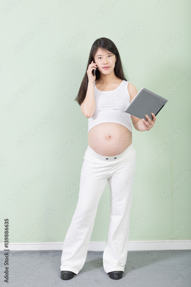 young pretty pregnant woman with tablet young pretty pregnant woman with tablet