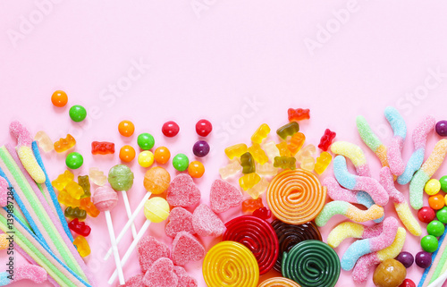 Colorful candy and fruit jelly jujube on a pink background