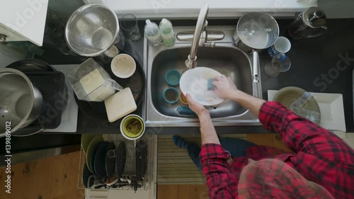 Timelapse of a man washing dishes