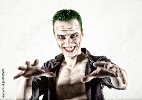 Bild auf Leinwand guy with crazy clown face, green hair