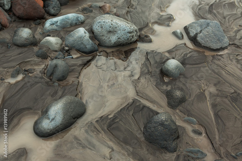 IL and stones on bottom of river Studenaya. Kamchatka Peninsula. photo