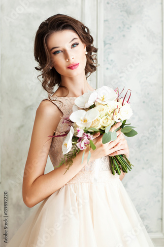 Beautiful young girl with a wedding bouquet